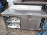 a stainless steel work table with two shelves on it