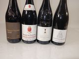 several bottles of wine are lined up on a counter top