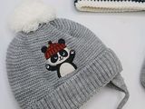 a knitted hat and mittens with a panda bear on it