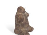 an image of a statue of a person sitting on a white surface