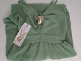 a small green bag with a gold ring on it