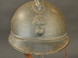 a silver helmet with a red ribbon on it