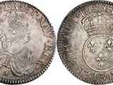 a silver coin with a crown on the front and a crown on the back
