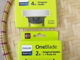 three oneblade blades are on the table next to a cup of coffee