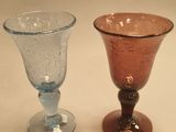 two wine glasses sitting next to each other on a table