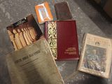 many old books on the floor next to each other