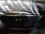 an image of a black purse on a bed