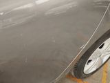 a close up of a car ' s paint job on the side of the road