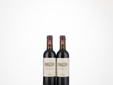 two bottles of wine sitting on top of a table next to each other