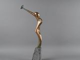 a bronze sculpture of a woman holding a flower on top of a marble block