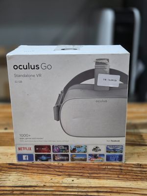 the box for the oculuss go headset is on a wooden table