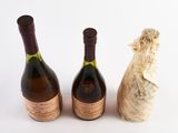 three bottles of wine sitting next to each other on a white surface