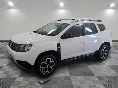 the white dacia is parked on a checkered tile floor