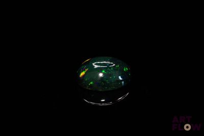 une photo d'une boule en verre noire et verte