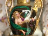 a vase with a picture of a woman and a swan on it