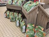 many bags of food sitting on the floor in the store
