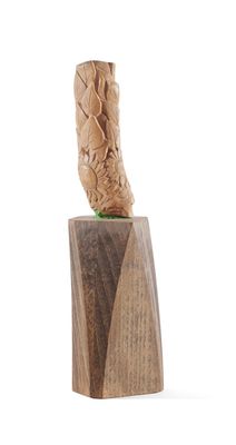 wooden sculpture of a bird on top of a block of wood