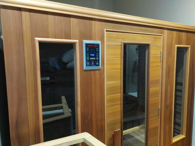 an image of a sauna room with a glass door