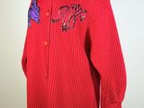 red sweater with purple dragon appliqued on the chest
