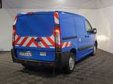 a blue van with red and white stripes parked in a garage