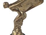 brass statue of a man holding a trumpet on a black base