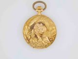 a picture of a gold locke with a woman ' s face on it