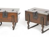pair of antique wooden trunks with metal handles on stands