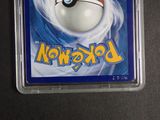 a pokemon card in a plastic holder on a table
