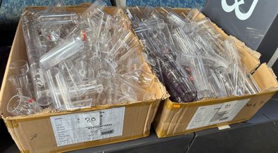 two boxes full of electronic devices on the shelf