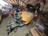 a tractor that is parked in a garage with other tractors