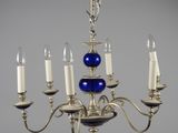 an image of a chandelier with five candles and a blue glass ball