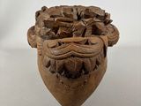 a wooden sculpture of a lion head with a bunch of flowers on it