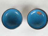 pair of blue and black ceramic knobs with a gold leaf on them