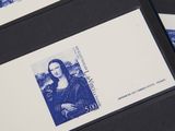 two envelopes with a picture of a woman on them on top of a table