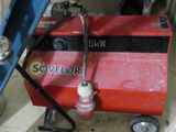 a red machine that is sitting in the garage