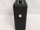 a black box with a gold button on it