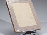 a picture of a picture frame on a stand with a piece of plastic covering it