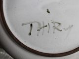 a close up of a white plate with the word thr written on it