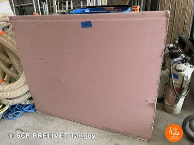 a pink refrigerator sitting in the middle of a room