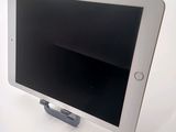 a tablet that is sitting on a stand on a table