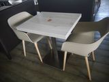 two chairs and a table in a small room