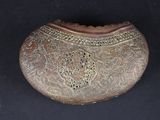 a small metal box with a decorative design on it