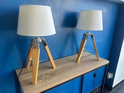 two lamps that are on top of a wooden table