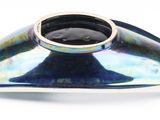 a metal object that is sitting on a white surface