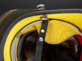 a close up of a yellow helmet with a black strap
