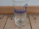 a glass of beer sitting on a wooden table