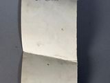 an old piece of paper with a note attached to it
