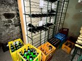 many bottles and crates of beer in a room