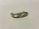 a small silver object on a white surface