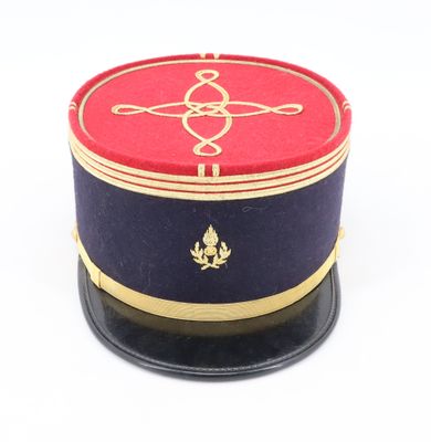 a red and blue hat with a gold emblem on it